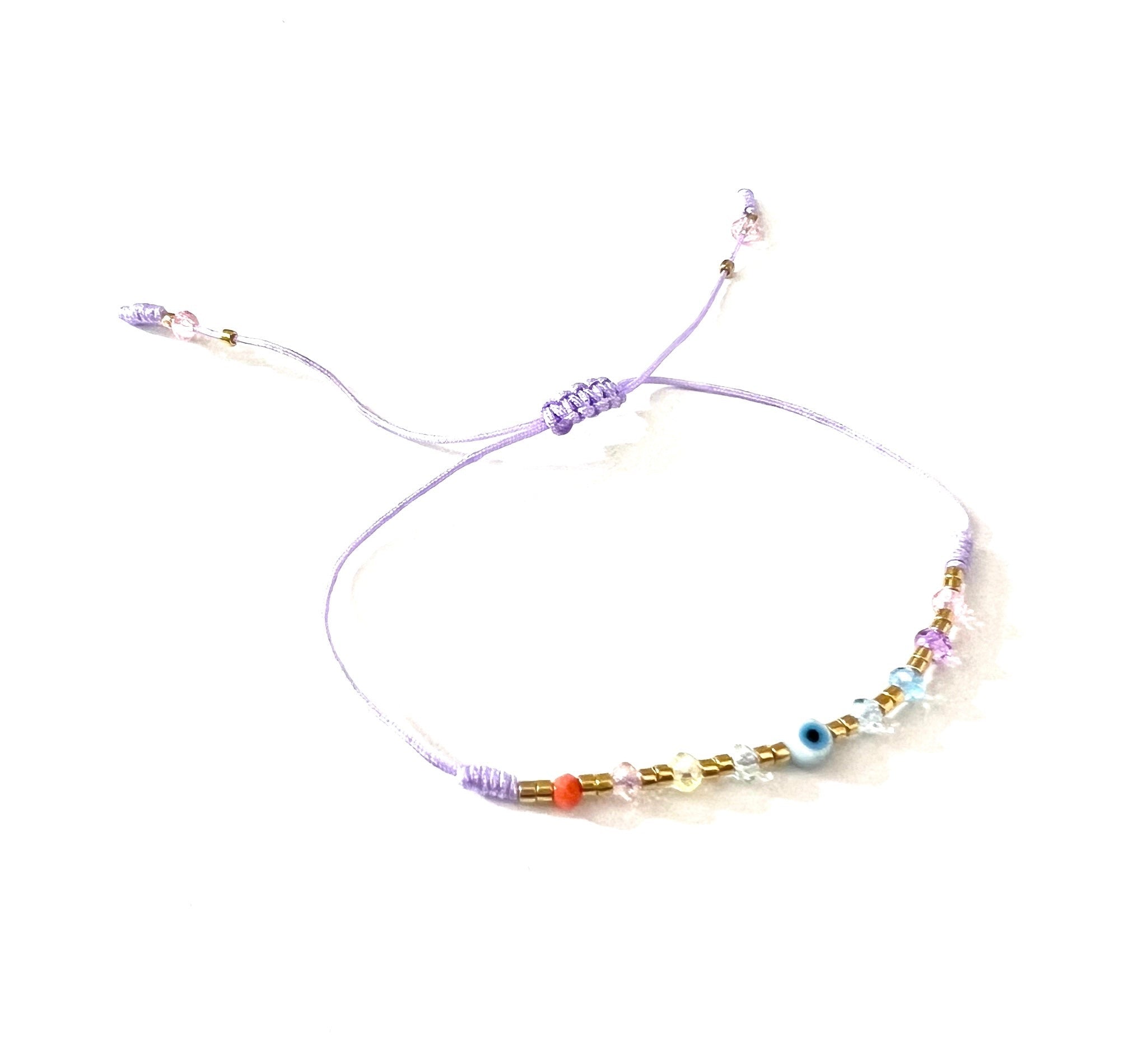 Pulsera ojitos cristalitos lila